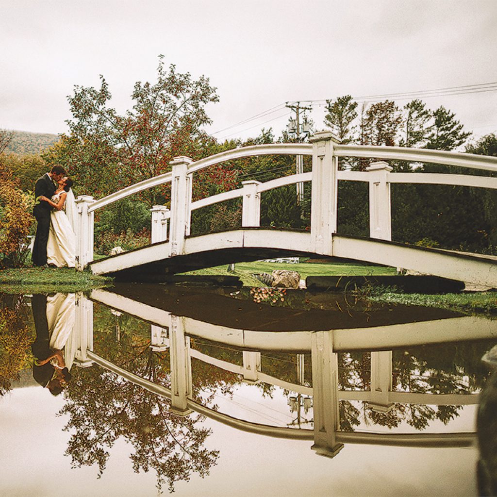 kissing bride by the bridge